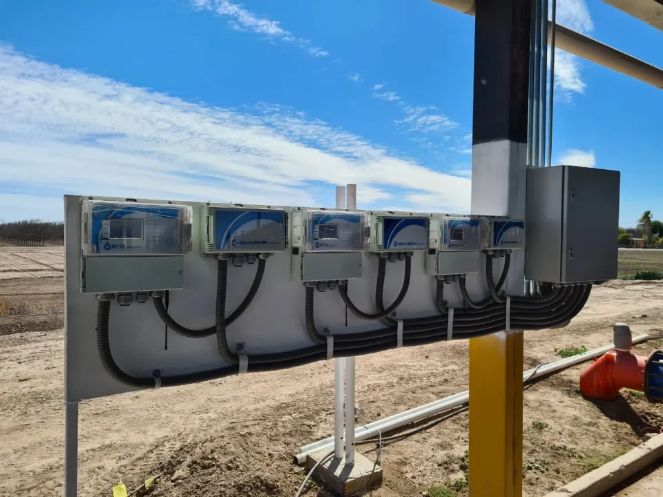 Multiple hardware units installed in neat rows across farmland, supporting diagnostics for smart irrigation troubleshooting