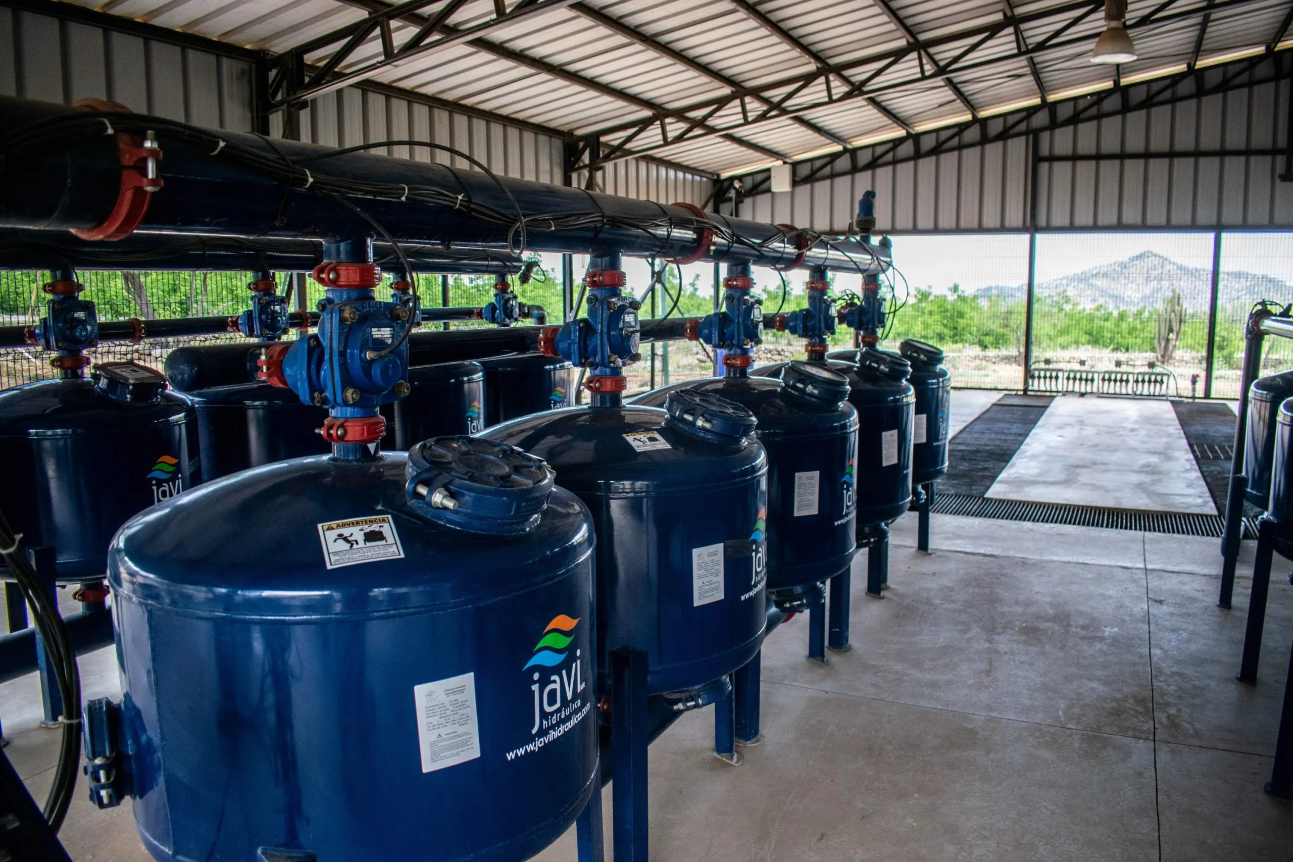 Agricultural infrastructure with pumps and tanks, optimizing water distribution via DROP CONTROL and irrigation control software